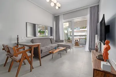 a living room with a couch and a table at Luxurious Coastal Retreat in Central Glyfada in Athens