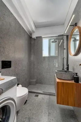 a bathroom with a sink and a toilet and a mirror at Luxurious Coastal Retreat in Central Glyfada in Athens
