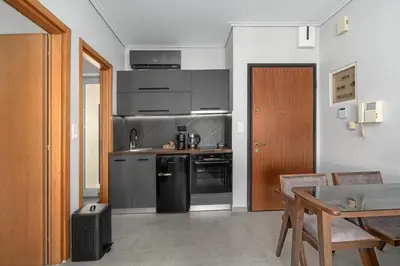 a kitchen with stainless steel appliances and a table at Luxurious Coastal Retreat in Central Glyfada in Athens
