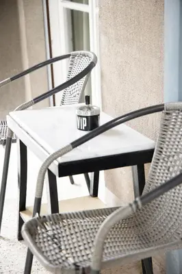 a table and two chairs on a porch at Alkisti in Athens
