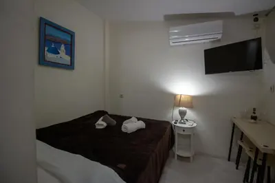 a bedroom with a bed with two pillows on it at Athens city center small penthouse in Athens