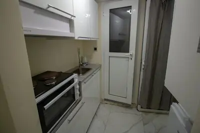 a small kitchen with a sink and a stove at Athens city center small penthouse in Athens