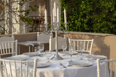 a table with candles and wine glasses on it at Athens city center small penthouse in Athens