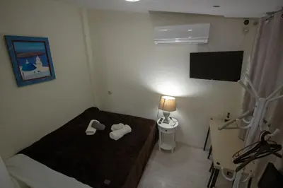 a small room with a bed and a toilet at Athens city center small penthouse in Athens