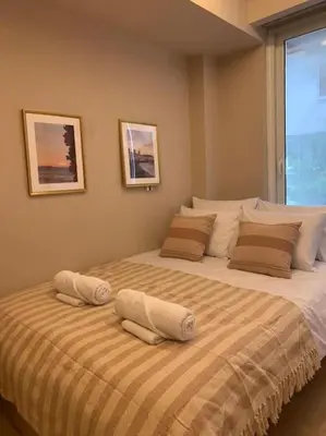a bedroom with two beds with towels on them at D-Marin Zea Marina 2 Bedroom in Piraeus