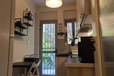 a kitchen with a sink and a counter top at \u8ff7\u4eba\u82b1\u56ed\u516c\u5bd3 Charming Garden in Athens