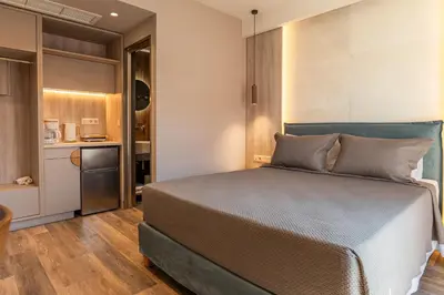 a bedroom with a bed and a small kitchen at Wellnest Hotel in Athens
