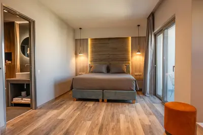 a bedroom with a bed and a large mirror at Wellnest Hotel in Athens