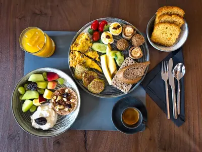 three plates of breakfast food on a table at Wellnest Hotel in Athens