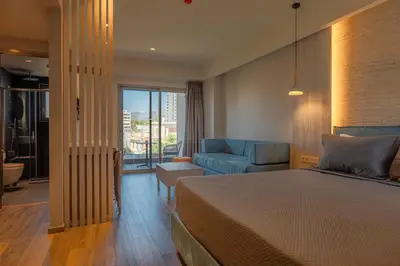 a hotel room with a bed and a couch at Wellnest Hotel in Athens