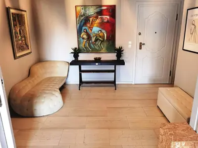a hallway with a table and a painting on the wall at 110 Sqm 2BD Edem beach luxury apartment in Athens
