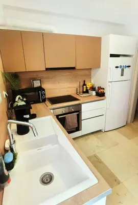 a kitchen with a sink and a white refrigerator at 110 Sqm 2BD Edem beach luxury apartment in Athens
