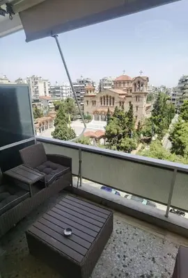 a room with a couch and a table on a balcony at 110 Sqm 2BD Edem beach luxury apartment in Athens