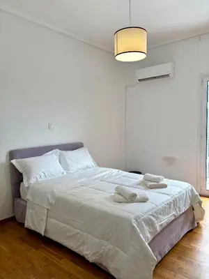 a bedroom with a bed with two towels on it at Dreaming of Greece G1 in Athens