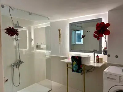 a white bathroom with a shower and a sink at Dreaming of Greece G1 in Athens