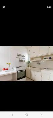 a kitchen with white cabinets and a stove top oven at Dreaming of Greece G1 in Athens