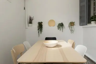 a dining room with a wooden table and chairs at Bright & Cozy House near Beach in Athens