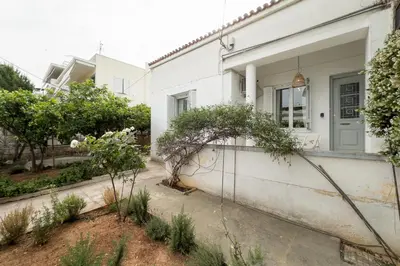 a house with a garden in front of it at Bright & Cozy House near Beach in Athens