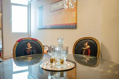 a glass table with two chairs with wine glasses at Athenian Urban Art Apartment - Live Athenian Life in Athens