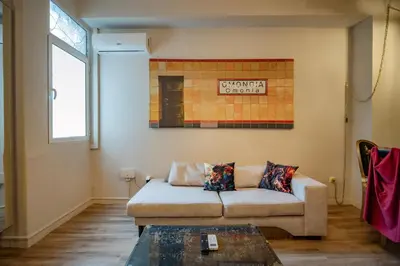 a living room with a couch and a table at Athenian Urban Art Apartment - Live Athenian Life in Athens