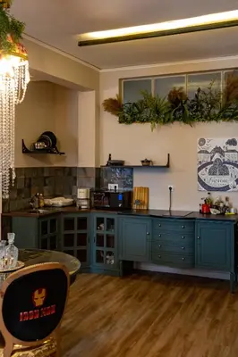 a kitchen with blue cabinets and plants on the wall at Athenian Urban Art Apartment - Live Athenian Life in Athens