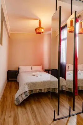 a bedroom with two beds and a mirror at Athenian Urban Art Apartment - Live Athenian Life in Athens
