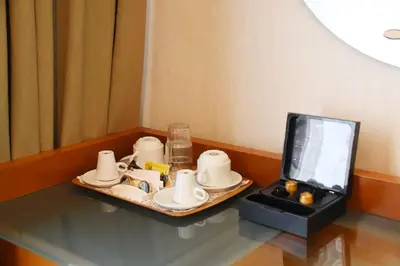 a tray of dishes on a table next to a tv at Adrian Hotel in Athens