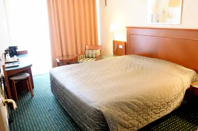 a hotel room with a bed and a desk at Adrian Hotel in Athens