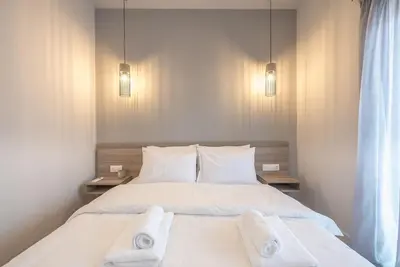 a bedroom with a bed with two towels on it at Elegant & Spacious Apartment in Athens