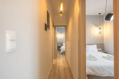 a view of a bedroom with a bed and a mirror at Elegant & Spacious Apartment in Athens