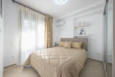 a bedroom with a large bed and a window at Acropolis Diamond in Athens