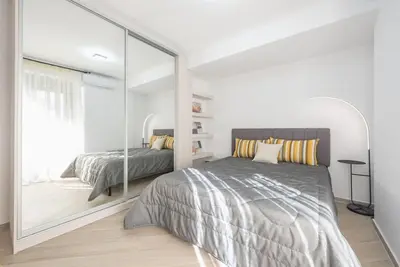a bedroom with a large mirror next to a bed at Acropolis Diamond in Athens