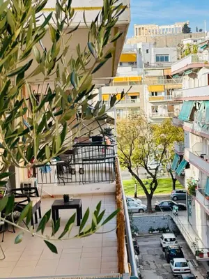 a balcony with a table and a view of a city at Acropolis Diamond in Athens