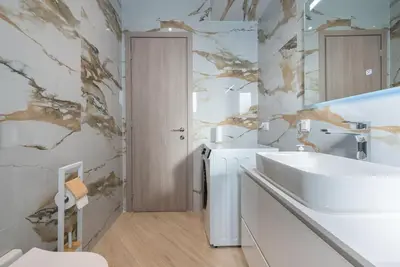 a white bathroom with a sink and a mirror at Acropolis Diamond in Athens