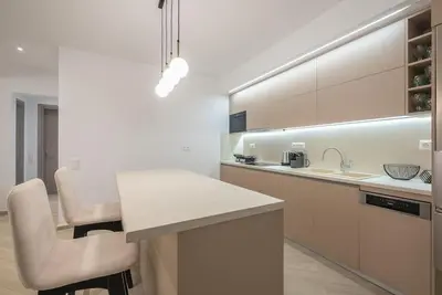 a white kitchen with a counter and a sink at Acropolis Diamond in Athens