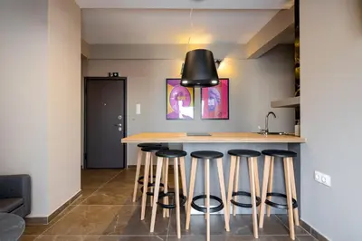 a kitchen with a island with bar stools at The Acropolis Pathway in Athens