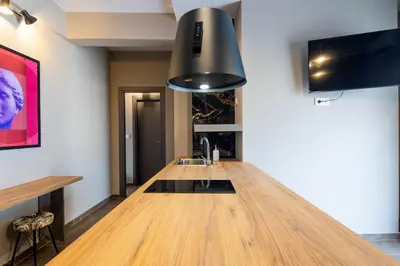 a kitchen with a wooden counter with a sink at The Acropolis Pathway in Athens