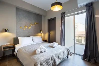 a bedroom with a bed with two towels on it at The Acropolis Pathway in Athens