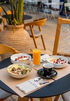 a table with plates of food and drinks on it at The Acropolis Pathway in Athens