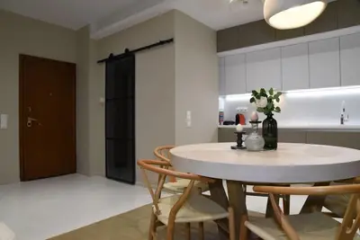 a kitchen with a table and chairs in a room at Elegant Central 2BR & 2 Ensuite Baths, Near Metro in Athens