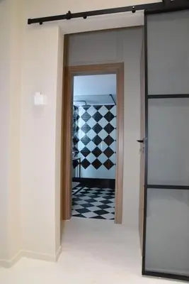 a hallway with a door to a room with a checkered floor at Elegant Central 2BR & 2 Ensuite Baths, Near Metro in Athens
