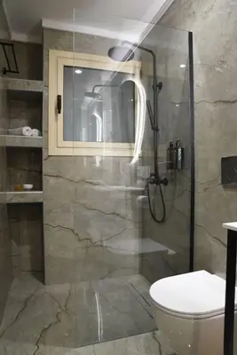 a bathroom with a shower and a toilet at Elegant Central 2BR & 2 Ensuite Baths, Near Metro in Athens