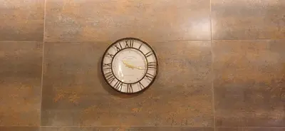 a clock on the side of a wall at ALPHA APARTMENTS Free Shuttle from and to the Airport in Spáta