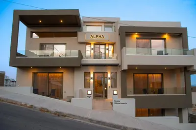 a large white building with lights on at ALPHA APARTMENTS Free Shuttle from and to the Airport in Spáta