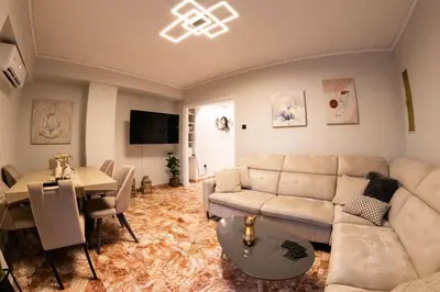 a living room with a couch and a table at Sympatico Glyfada Downtown in Athens
