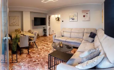a living room with a couch and a table at Sympatico Glyfada Downtown in Athens