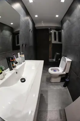 a bathroom with a white sink and a toilet at Sympatico Glyfada Downtown in Athens