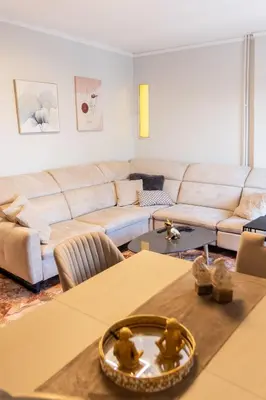 a living room with a couch and a table at Sympatico Glyfada Downtown in Athens