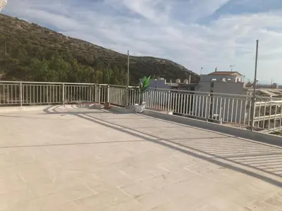 a cat sitting on a bridge with a fence at Athens Palaia Fokaia Entire Flat 2 bedrooms with panoramic sea views and a massive veranda , only steps away from the beach and amenities in Palaiá Fókaia