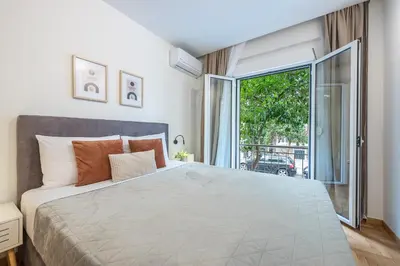 a bedroom with a large bed and a large window at Athens Home in Athens